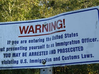 A sign at the international boundary between Canada and the United States in Point Roberts, Washington.